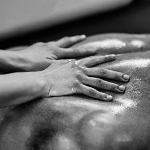 stock-photo-sports-massage-lower-back-massage-physical-therapist-doing-massage-of-lower-back-black-and-402722113